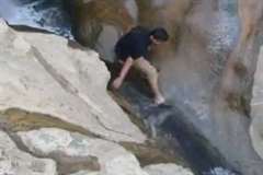 濡れた岩は滑る・・・滝を滑り落ちて行く男性