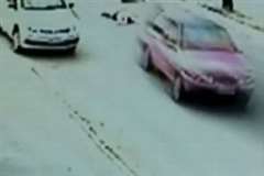 道路を横断中の女性を轢き逃げする車
