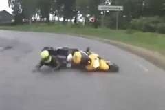 カーブで転倒したバイクが道路を滑りながら突っ込んでくる