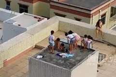 屋上の貯水槽に入って遊ぶ子供たち